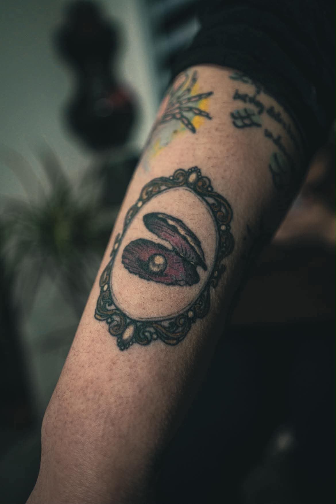 Oyster and pearl in an ornate cameo frame, colour, forearm — by Stefan Buttigieg at Ink Alley, Żabbar